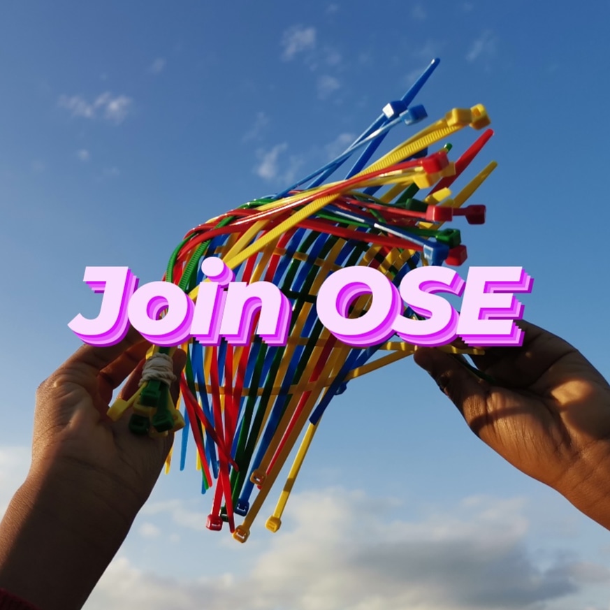 hands holding a multicoloured object infront of a blue sky with the words 'Join OSE' over the top in a bold pink font